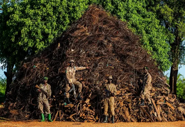 Murchison Falls rangers pictured in front of the "snare mountain".
