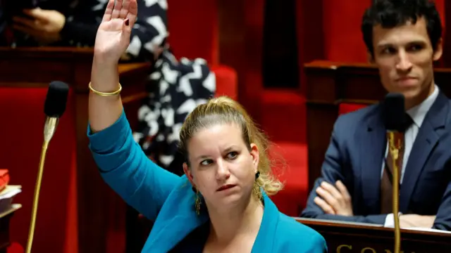 Mathilde Panot, president of La France Insoumise, raises her hand in the National Assembly