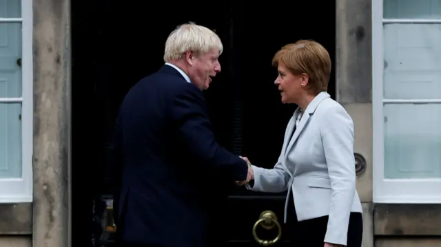 Boris Johnson shaking hands with Nicola Sturgeon