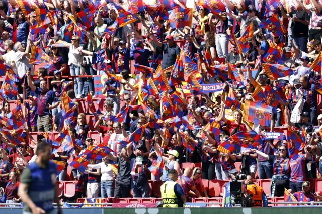 Barcelona fans hold up scarves