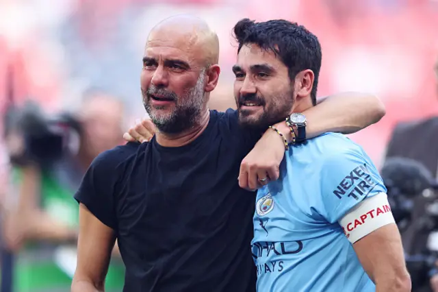 Gundogan and Pep hold each other tightly