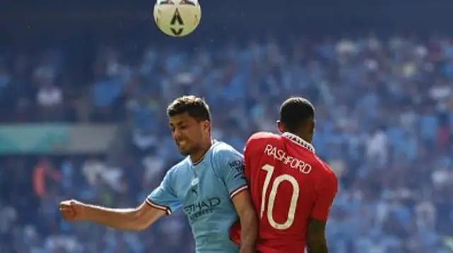 Rashford battles with Rodri in the air