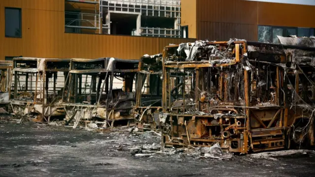 View of burnt buses at a RATP bus depot damaged during night clashes between protesters and police,