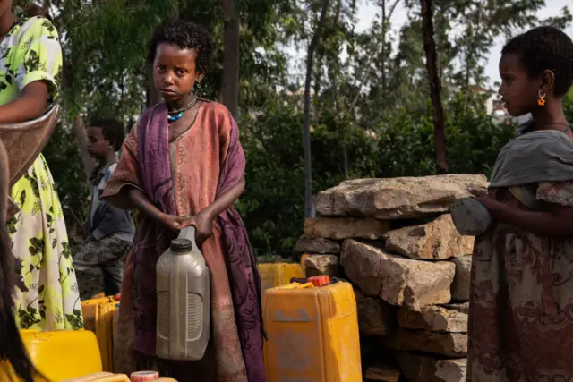 A girl carries a jerrycan of drinking water on the outskirts of Mekele, the capital of Tigray in May.