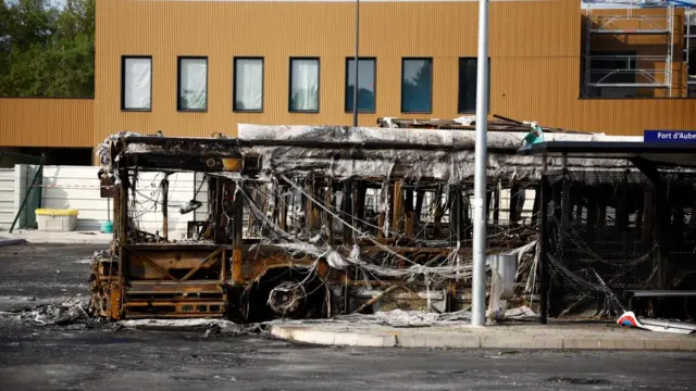 View of a burnt bus at a RATP bus depot damaged during night clashes