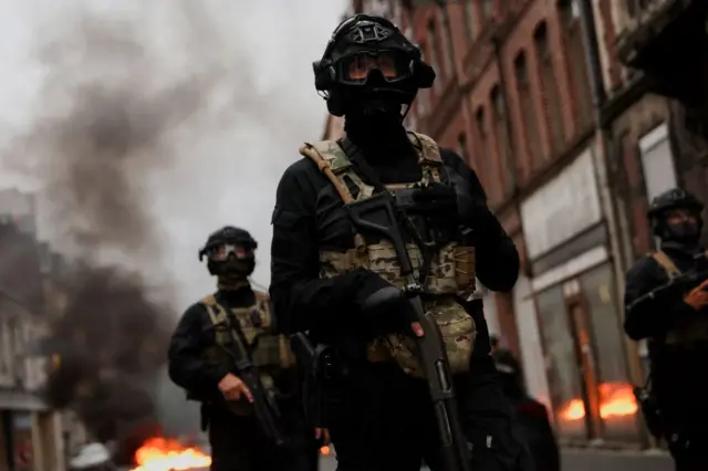 Officers stand guard during riots in Lille, France