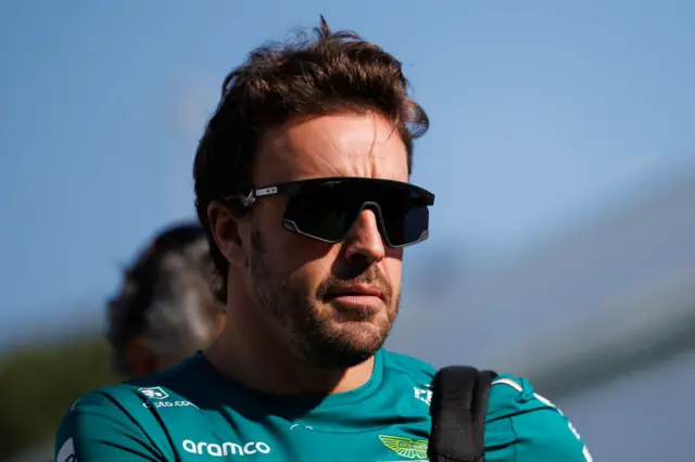 Fernando Alonso arrives in the paddock in Barcelona