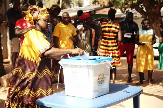 A voter casts her ballot at a polling station in Bissau on June 04, 2023.