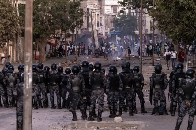 Senegalese security forces block a road after protests burned tires and blocked roads in Dakar, on June 3, 2023