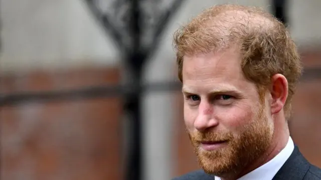 Prince Harry walks outside the High Court, in London on 30 March