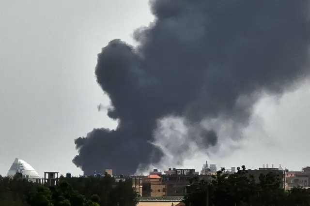 Smoke billows behind buildings from a reported fire in Khartoum, on June 5, 2023