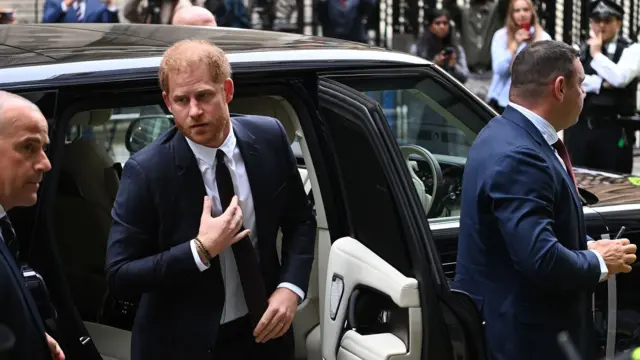 Prince Harry gets out of his car outside the High Court