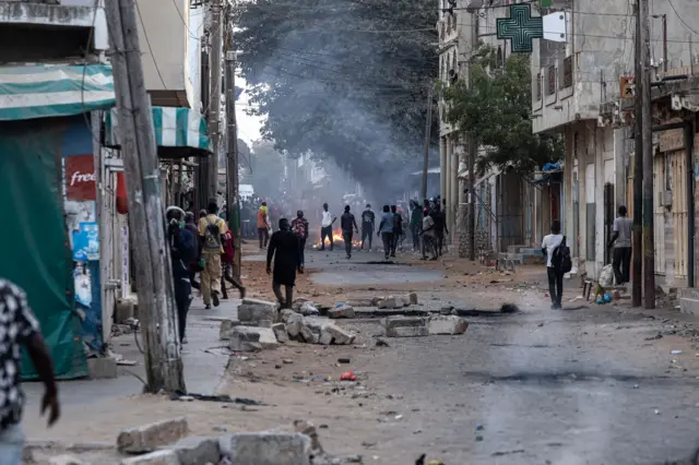 rotestors light fires and block streets in Dakar, on June 3, 2023, two days after a court in Senegal sentenced opposition leader Ousmane Sonko,