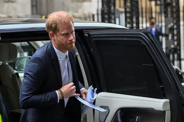 Prince Harry leaves a car outside the High Court