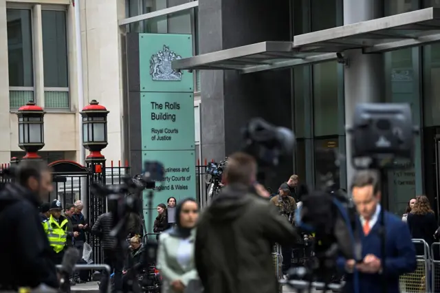 Media stand in front of the Rolls Building in central London