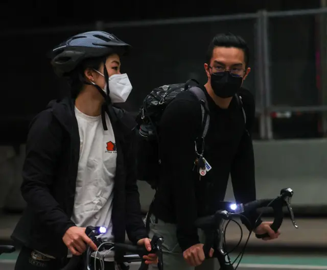 People ride with masks as air quality remains poor in New York City