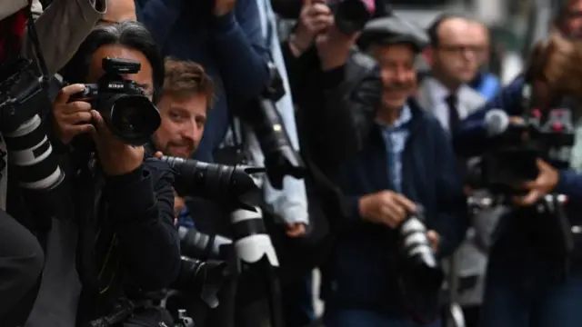 Photographers outside court