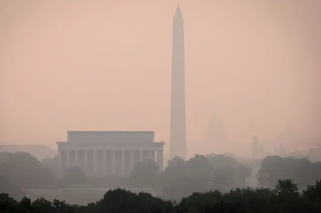 Hazy skies caused by Canadian wildfires blanket the monuments and skyline of Washington DC