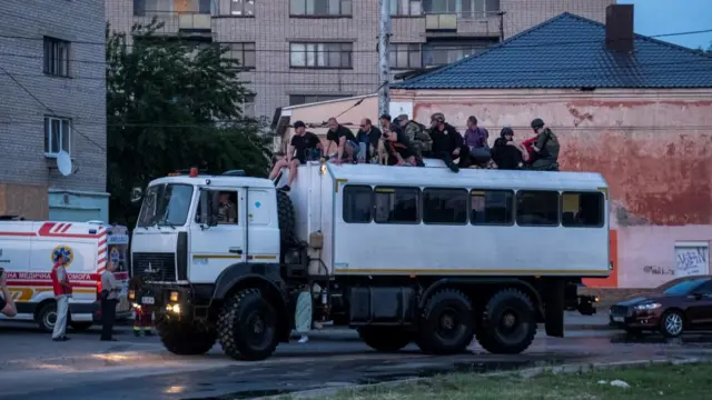 Rescuers evacuate local residents from a flooded area after the Nova Kakhovka dam breached