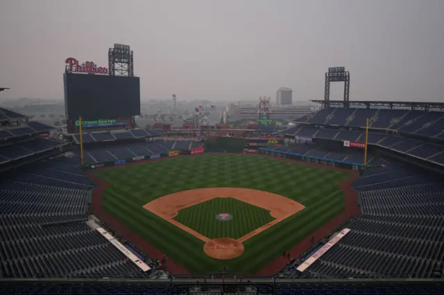 Philadelphia's baseball stadium sits empty in a blanket of smoke. A game between the Phillies and Detroit was cancelled on Wednesday due to the smoke.