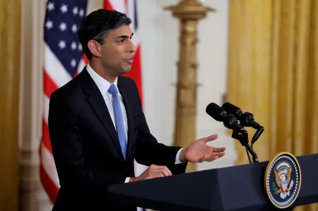 Sunak speaks at a lectern