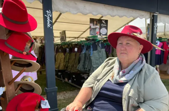 Tina Dorrell trying on a hat at the show