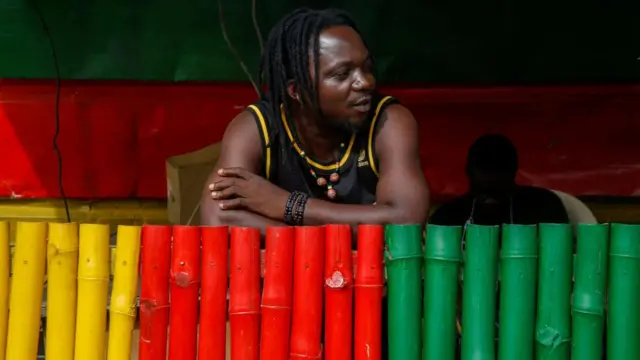 A man at bar, at Rasta junction in Colombie, a slum of Abidjan, Ivory Coast - 3 June 2023