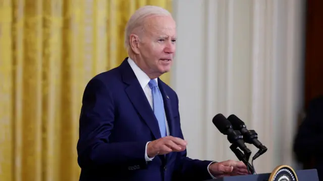 President Joe Biden speaks at a lecturn