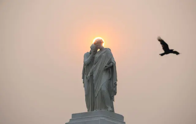 The sun rises behind the Peace Monument in Washington DC on 8 June 2023