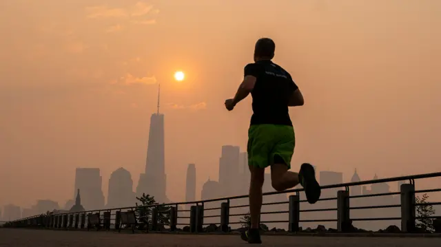 A jogger in front of the New York City skyline