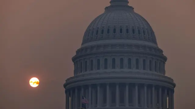 Smoke from wildfires casts a haze over US Capitol at sunrise on 8 June, 2023