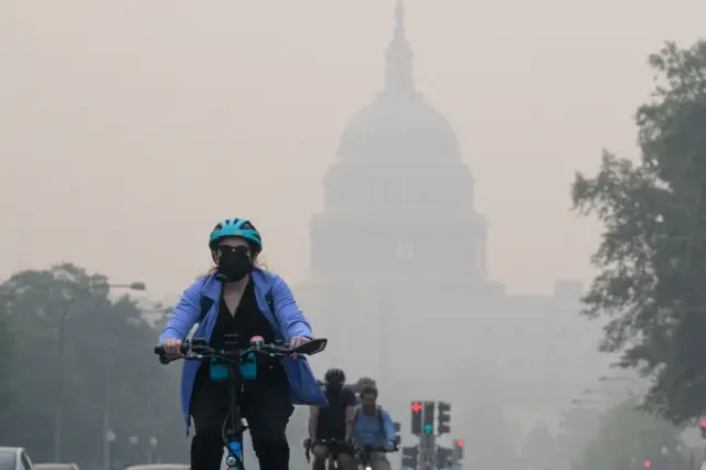 Americans bike in smog