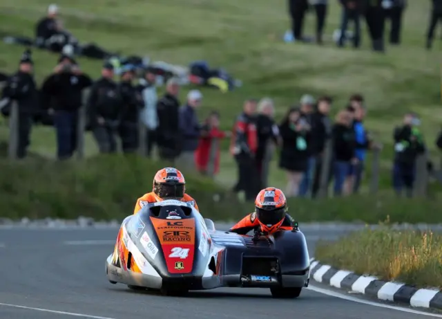 Michael Russell and passenger Vicky Cooke in action in the sidecar class