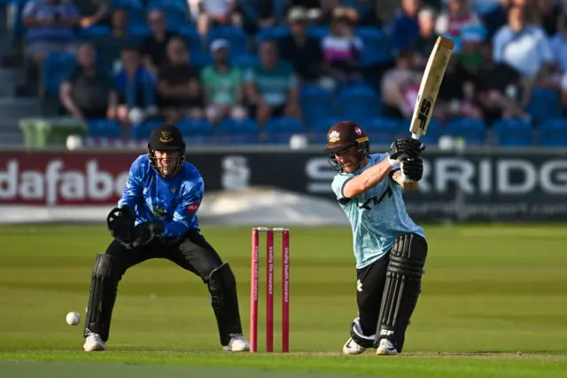 Surrey's Laurie Evans hits a boundary at Sussex