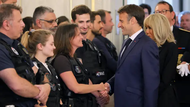 French President Emmanuel Macron and his wife Brigitte Macron meet rescue forces at the Haute-Savoie prefecture