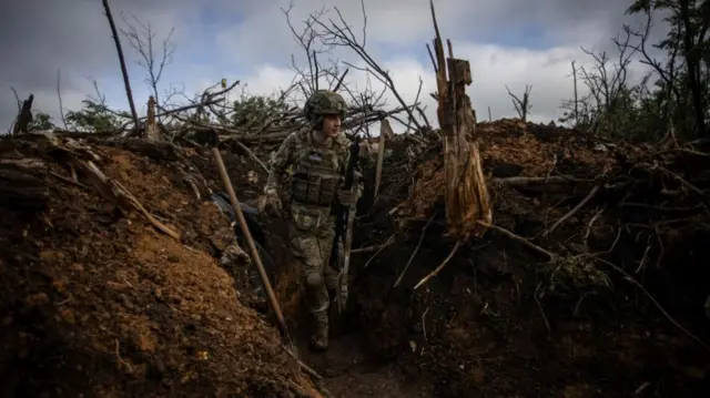 Ukrainian solider in a trench near Bakhmut