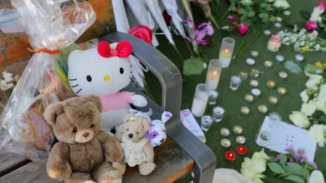 Teddy bears, candles and handwritten notes are pictured in the playground