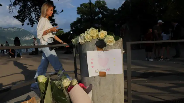 A general view of flowers and a message left at the Le Paquier park, after several children and adults were injured in a knife attack, near the lake in Annecy, in the French Alps, France, June 8, 2023.