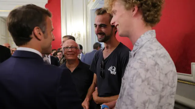 French President Emmanuel Macron meets Henri, the 24-year-old 'backpack hero