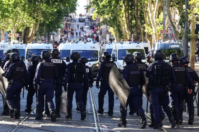 Police officers walk during protests in Marseille, southern France, on 1 July 2023