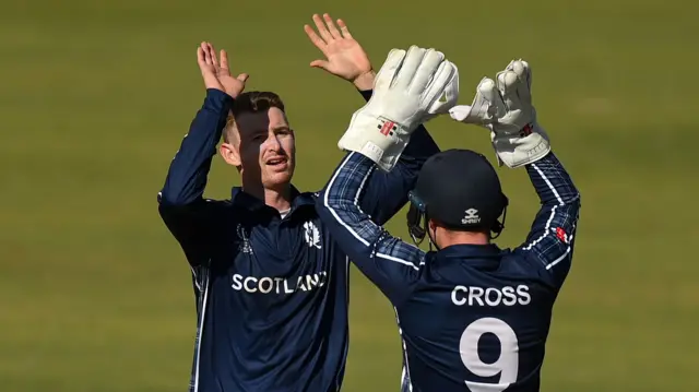 Brandon McMullen celebrates with Matthew Cross