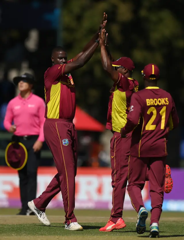 Jason Holder is congratulated by teammates after his wicket