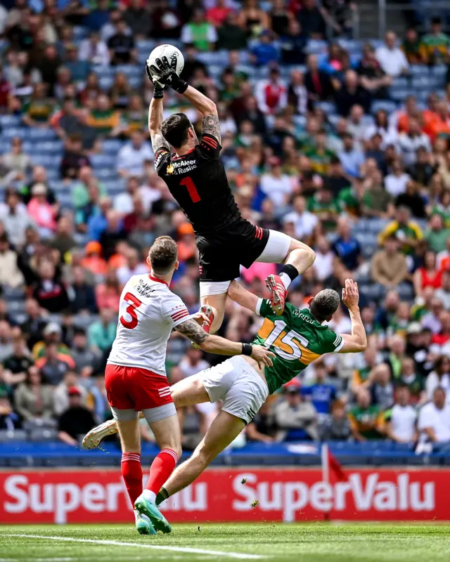 Tyrone goalkeeper Niall Morgan catches the ball above teammate Ronan McNamee and Paul Geaney of Kerry