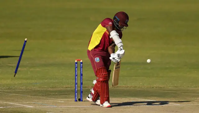 Kyle Mayers' off-stump flies through the air, removed from the ground by Chris Sole