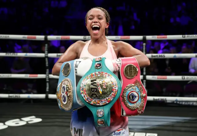 Natasha Jonas celebrates with the WBC, WBO, IBF light-middleweight titles