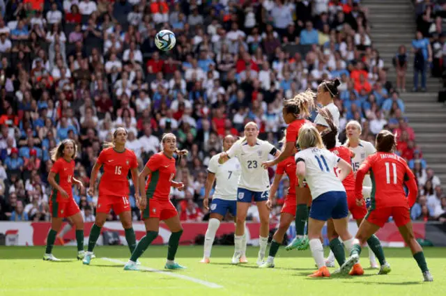 Lucy Bronze heads the ball against the post