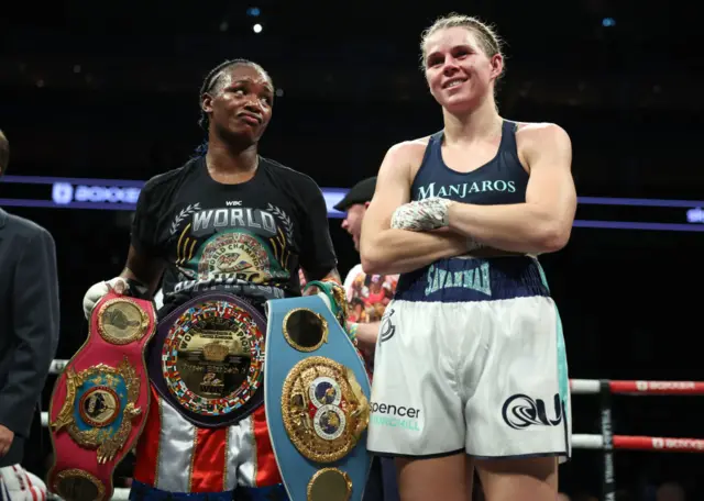 Claressa Shields holds the middleweight titles next to Savannah Marshall