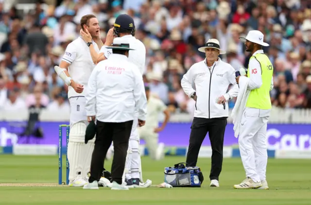 Stuart Broad gets treatment after being hit on the helmet by a bouncer