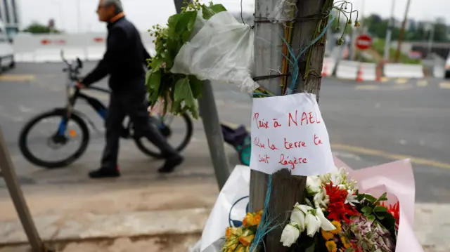 Flowers are seen at the site where Nahel was killed by a French police officer