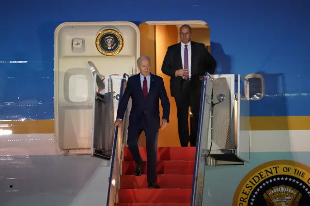 Joe biden walking down the steps of Air Force One